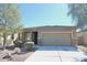 Charming single-story home featuring a two-car garage, low maintenance landscaping, and a welcoming entrance at 38133 W Vera Cruz Dr, Maricopa, AZ 85138