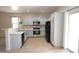 Bright kitchen featuring stainless steel appliances, stylish backsplash, breakfast bar, and sliding door access at 38133 W Vera Cruz Dr, Maricopa, AZ 85138