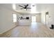 Spacious open-concept living area leading to the kitchen with stainless steel appliances at 38133 W Vera Cruz Dr, Maricopa, AZ 85138