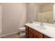 Well-lit bathroom with a single sink vanity, mirror, and a toilet at 42424 N Gavilan Peak Pkwy # 57104, Anthem, AZ 85086