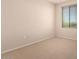 Cozy bedroom with neutral carpet and a window offering natural light at 42424 N Gavilan Peak Pkwy # 57104, Anthem, AZ 85086