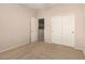 Carpeted bedroom with a closet and an open doorway to an adjacent room at 42424 N Gavilan Peak Pkwy # 57104, Anthem, AZ 85086