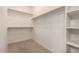 Walk-in closet with built-in shelves and hanging rods, perfect for organization at 42424 N Gavilan Peak Pkwy # 57104, Anthem, AZ 85086