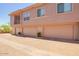 Exterior of a multi-story building with multiple garages and brick pavers at 42424 N Gavilan Peak Pkwy # 57104, Anthem, AZ 85086