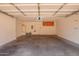 Spacious garage with concrete floor, overhead storage and bright lighting at 42424 N Gavilan Peak Pkwy # 57104, Anthem, AZ 85086