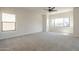 Spacious bedroom featuring plush carpeting, ample natural light, and a modern ceiling fan at 44538 W Canyon Creek Dr, Maricopa, AZ 85139