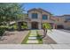 Charming two-story home with a desert landscape, enhanced by a modern walkway and inviting curb appeal at 44538 W Canyon Creek Dr, Maricopa, AZ 85139