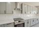 Close-up view of a modern kitchen with stainless steel appliances and gray subway tile backsplash at 44538 W Canyon Creek Dr, Maricopa, AZ 85139
