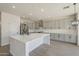 Contemporary kitchen boasts a large island, stainless steel appliances, and sleek gray cabinetry at 44538 W Canyon Creek Dr, Maricopa, AZ 85139