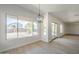 Bright, open living room with large windows, neutral walls, and light flooring at 44538 W Canyon Creek Dr, Maricopa, AZ 85139