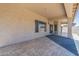 The covered patio has neutral tile flooring and plenty of space to enjoy the outdoors at 44538 W Canyon Creek Dr, Maricopa, AZ 85139