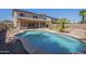 This backyard features a refreshing pool, perfect for hot summer days, with desert landscaping at 44538 W Canyon Creek Dr, Maricopa, AZ 85139