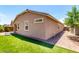 An inviting backyard featuring lush artificial turf, brick pavers and a stucco wall at 45424 W Norris Rd, Maricopa, AZ 85139