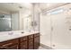 Bathroom boasts a double sink vanity with a walk-in shower featuring a built-in seat at 45424 W Norris Rd, Maricopa, AZ 85139