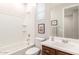 Clean bathroom features a tub with tile surround, a vanity, and neutral finishes at 45424 W Norris Rd, Maricopa, AZ 85139