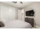 Cozy bedroom features a large wardrobe, a modern TV, and a comfortable bed at 45424 W Norris Rd, Maricopa, AZ 85139