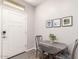 Bright entryway featuring a drop-leaf table with seating and decorative artwork at 45424 W Norris Rd, Maricopa, AZ 85139
