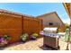 Outdoor grilling area featuring a high-end stainless steel grill and potted flowers at 45424 W Norris Rd, Maricopa, AZ 85139