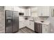 Bright kitchen featuring white cabinets, stainless steel appliances, and sleek countertops at 45424 W Norris Rd, Maricopa, AZ 85139