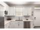 Stylish kitchen features white cabinets, stainless steel appliances, and a modern sink at 45424 W Norris Rd, Maricopa, AZ 85139