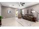 Spacious living room with a ceiling fan, neutral paint, and modern tile flooring at 45424 W Norris Rd, Maricopa, AZ 85139