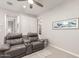 Comfortable living room featuring a plush gray reclining sofa and overhead ceiling fan at 45424 W Norris Rd, Maricopa, AZ 85139