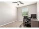 Dedicated office space with a built-in desk, chair, and natural light from the window at 45424 W Norris Rd, Maricopa, AZ 85139