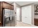 Kitchen pantry with stainless steel refrigerator and shelving at 45424 W Norris Rd, Maricopa, AZ 85139