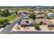 This aerial view showcases the property's tile roof, three-car garage, and mature landscaping at 5529 E Holmes Ave, Mesa, AZ 85206