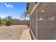Backyard featuring desert landscaping, gravel, a screened-in patio, and privacy walls, with tropical foliage at 5529 E Holmes Ave, Mesa, AZ 85206