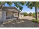 Backyard featuring desert landscaping, gravel, palm trees, privacy walls, and a screened-in patio at 5529 E Holmes Ave, Mesa, AZ 85206