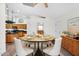 Bright dining room featuring modern furniture, a round table, tile flooring, and access to the kitchen at 5529 E Holmes Ave, Mesa, AZ 85206