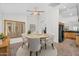 A dining room with modern furniture, tile flooring, natural lighting, and a ceiling fan at 5529 E Holmes Ave, Mesa, AZ 85206