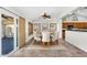 Open dining area with view of slider door, shutters, and the kitchen area at 5529 E Holmes Ave, Mesa, AZ 85206