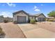 Charming single-story home featuring a tile roof, desert landscaping, and a three-car garage at 5529 E Holmes Ave, Mesa, AZ 85206