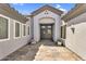 Exterior shot of the front door and entryway featuring a tile walkway and covered entry at 5529 E Holmes Ave, Mesa, AZ 85206