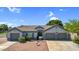 Charming single-story home featuring a tile roof, three-car garage, and inviting desert landscaping at 5529 E Holmes Ave, Mesa, AZ 85206