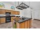 Bright, open concept kitchen featuring wood cabinets, dark countertops, stainless appliances, and tile flooring at 5529 E Holmes Ave, Mesa, AZ 85206