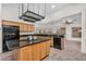 A spacious kitchen features a center island, granite countertops, wood cabinets, and stainless-steel appliances at 5529 E Holmes Ave, Mesa, AZ 85206