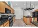 Bright kitchen with wooden cabinets, a dark countertop, stainless steel appliances, and a center island at 5529 E Holmes Ave, Mesa, AZ 85206