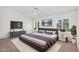 A spacious main bedroom with neutral tones, carpet, and modern decor at 5529 E Holmes Ave, Mesa, AZ 85206