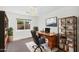 Comfortable home office with ceiling fan, a nice desk, and a wall mounted TV at 5529 E Holmes Ave, Mesa, AZ 85206