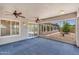 Screened-in patio with blue carpet and a view of the gravel desert landscaping at 5529 E Holmes Ave, Mesa, AZ 85206