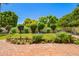 Manicured backyard with a beautiful brick patio and colorful flowerbeds creating an inviting outdoor retreat at 5613 E Calle Del Paisano --, Phoenix, AZ 85018