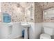 Charming powder room with floral wallpaper, white wainscoting, and pedestal sink at 5613 E Calle Del Paisano --, Phoenix, AZ 85018