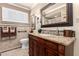 Beautiful bathroom with a dark wood vanity, granite countertop, and decorative mirror at 5613 E Calle Del Paisano --, Phoenix, AZ 85018