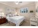 Cozy bedroom featuring a comfortable queen-sized bed and a bright window view at 5613 E Calle Del Paisano --, Phoenix, AZ 85018