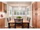 Bright dining area with shuttered windows, built-in cabinets, and a stylish pendant light fixture at 5613 E Calle Del Paisano --, Phoenix, AZ 85018