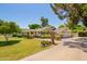 Well-manicured front lawn with an expansive circular driveway and two car garage at 5613 E Calle Del Paisano --, Phoenix, AZ 85018