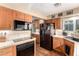 Modern kitchen with wood cabinetry, a full suite of appliances, and tile countertops at 5613 E Calle Del Paisano --, Phoenix, AZ 85018